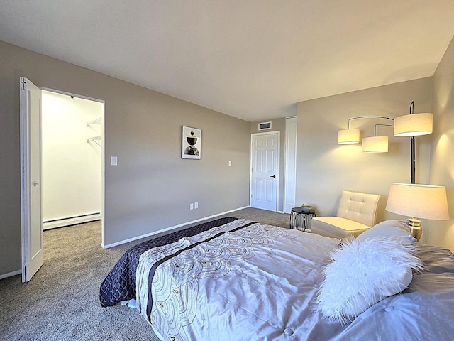 bedroom featuring a spacious closet, a baseboard radiator, carpet, and a closet