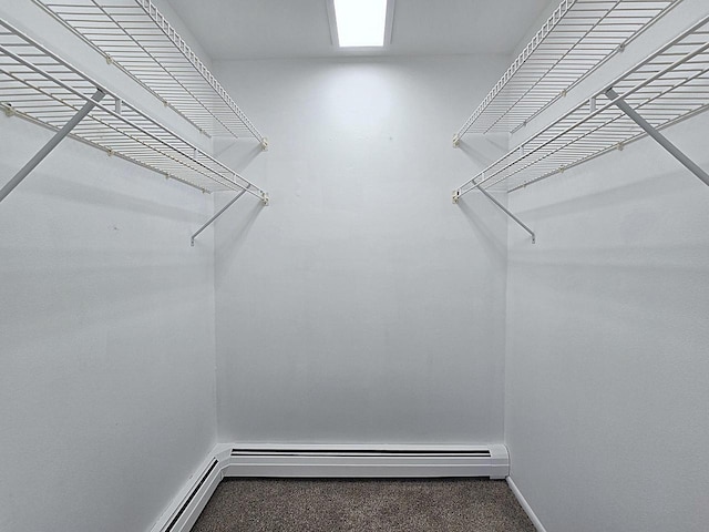 walk in closet with a baseboard radiator