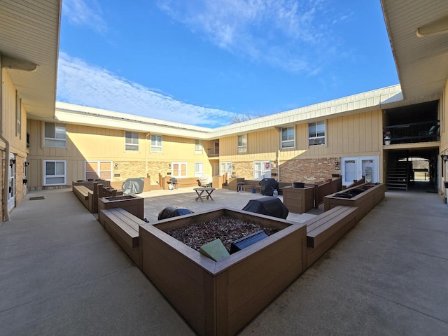 view of patio featuring an outdoor fire pit and a grill