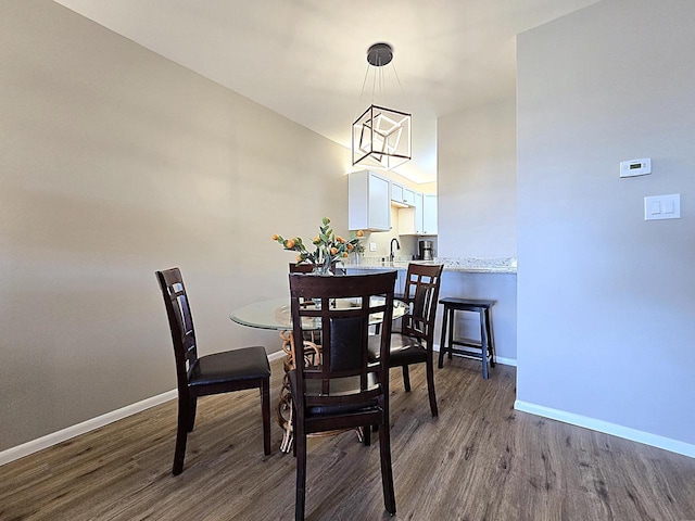 dining room with a chandelier, hardwood / wood-style flooring, and sink