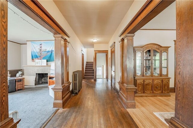1010 S Farwell St, Eau Claire, WI 54701 - hall with ornate columns, carpet floors, and radiator heating unit