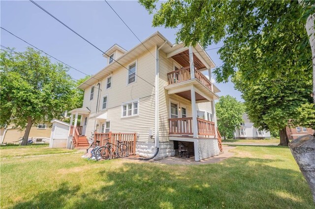 1010 S Farwell St, Eau Claire, WI 54701 - back of property with a lawn and a balcony
