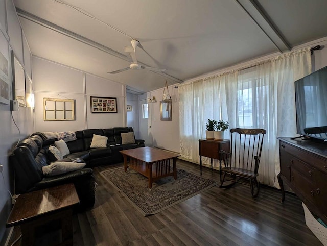 living room featuring ceiling fan, vaulted ceiling with beams, and dark hardwood / wood-style floors