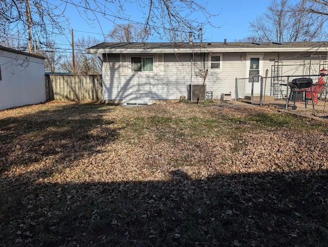 rear view of house featuring a lawn