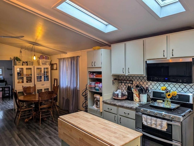 kitchen with double oven range, white cabinetry, decorative backsplash, dark wood-type flooring, and vaulted ceiling