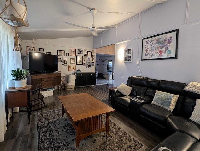 living room with ceiling fan, lofted ceiling, and dark hardwood / wood-style floors