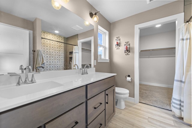 bathroom with hardwood / wood-style flooring, toilet, and vanity