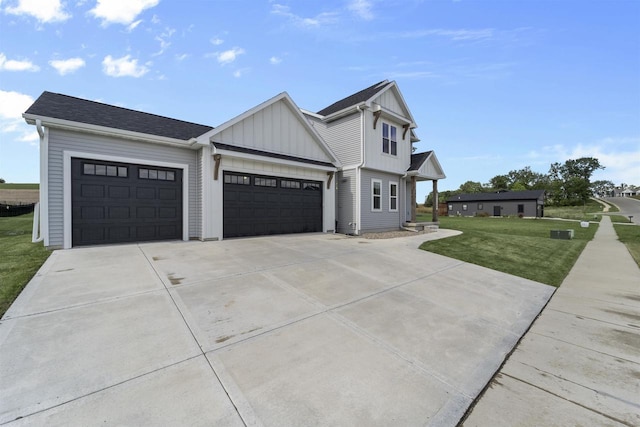 view of front of property featuring a front lawn and a garage