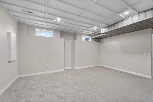 basement featuring light colored carpet