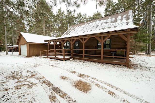 snow covered house with a garage