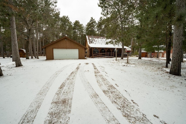 view of front facade featuring a garage and an outbuilding