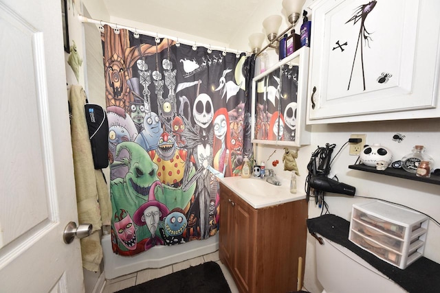 bathroom with shower / bathtub combination with curtain, tile patterned floors, and vanity