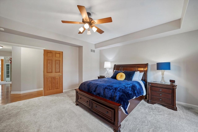 bedroom featuring ceiling fan and light carpet