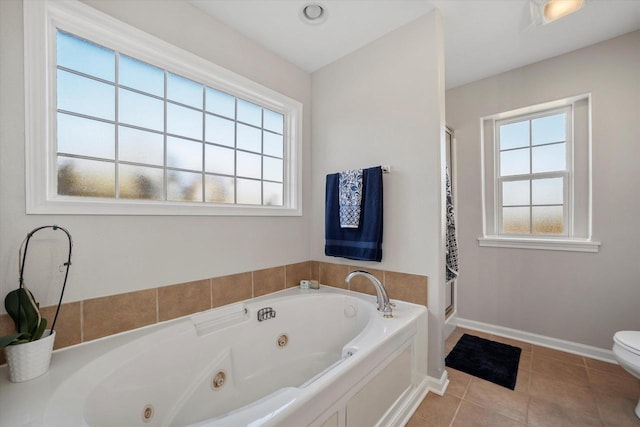 bathroom with toilet, a healthy amount of sunlight, separate shower and tub, and tile patterned floors