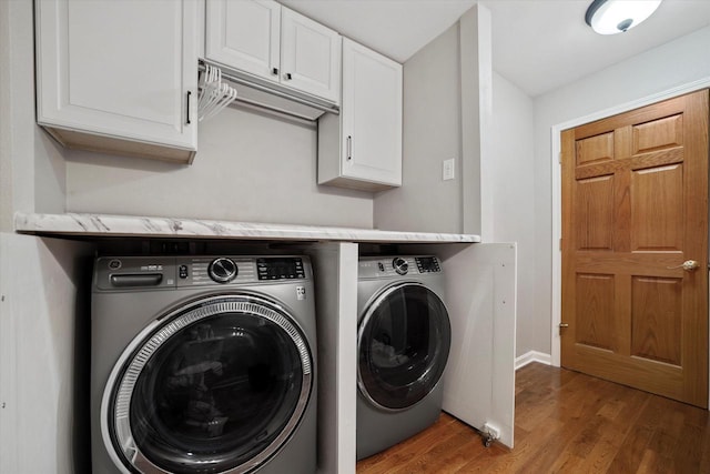 clothes washing area featuring independent washer and dryer and hardwood / wood-style floors