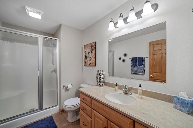 bathroom with vanity, toilet, tile patterned flooring, and an enclosed shower