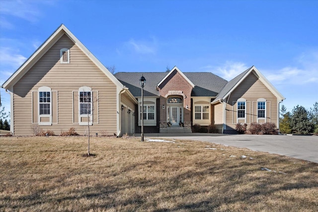 view of front of house with a front yard and a garage