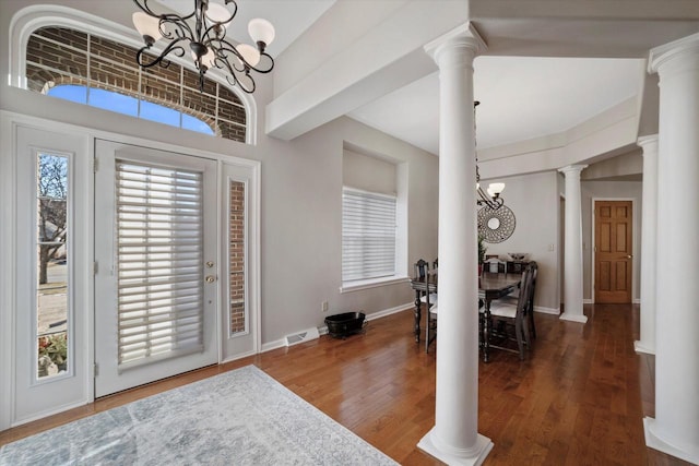 foyer featuring a high ceiling, dark hardwood / wood-style flooring, and a chandelier