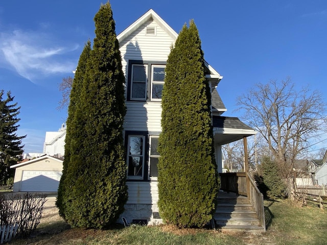 view of side of property featuring a garage and an outdoor structure