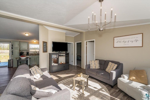 living room featuring sink, lofted ceiling, dark hardwood / wood-style floors, and a notable chandelier