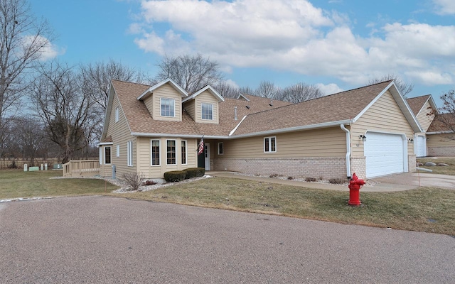 view of front of home with a front yard and a garage