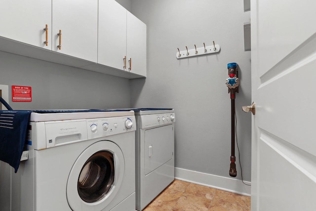 laundry room with cabinets and washer and clothes dryer