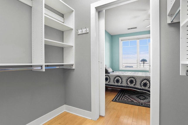 walk in closet featuring hardwood / wood-style flooring