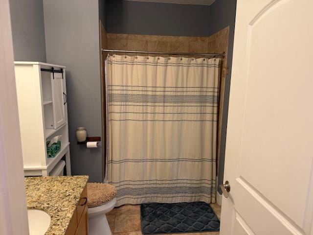 bathroom featuring vanity, toilet, tile patterned floors, and curtained shower