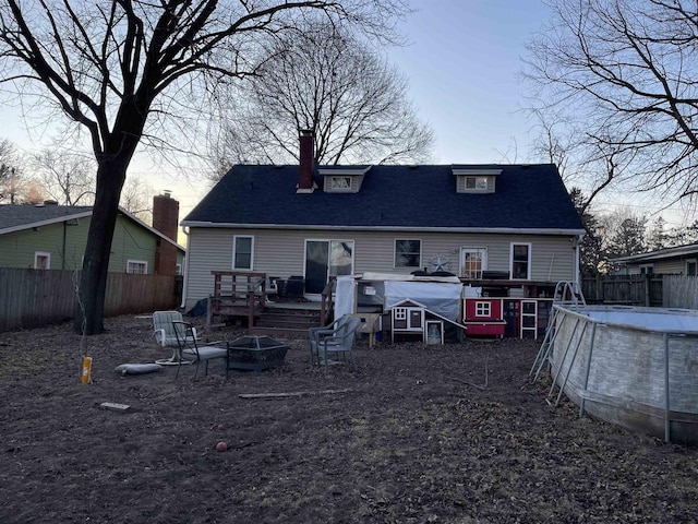 back house at dusk with a fire pit