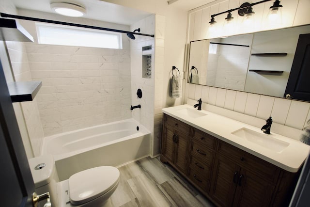 full bathroom featuring toilet, tiled shower / bath, backsplash, vanity, and hardwood / wood-style floors