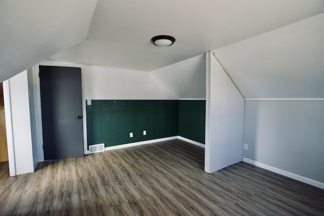 bonus room featuring vaulted ceiling and dark hardwood / wood-style floors