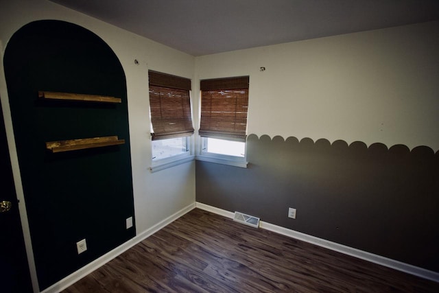 spare room featuring dark wood-type flooring