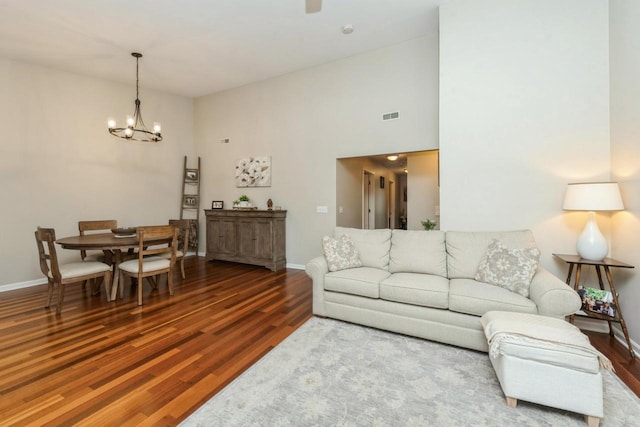 living room with hardwood / wood-style floors and an inviting chandelier