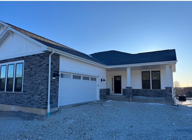 view of front of home with a porch and a garage