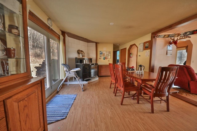 dining room featuring a wood stove and light hardwood / wood-style flooring