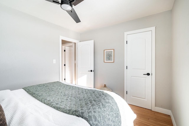 bedroom with ceiling fan and wood-type flooring