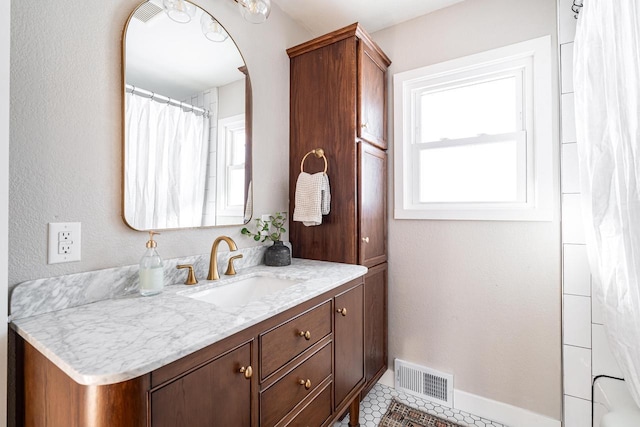 bathroom with tile patterned floors and vanity