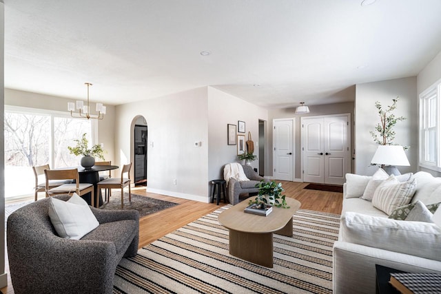 living room with hardwood / wood-style floors and a chandelier