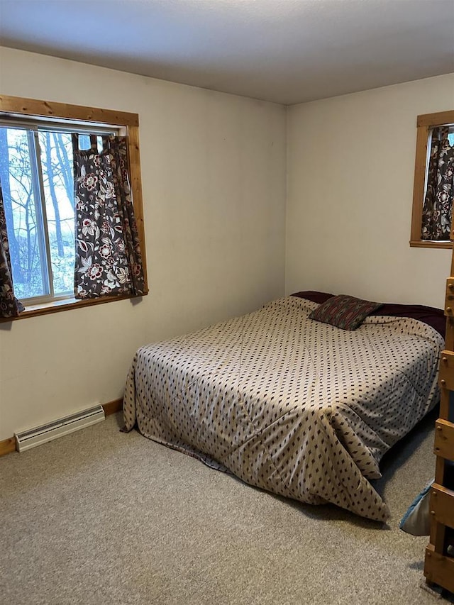 carpeted bedroom with baseboard heating