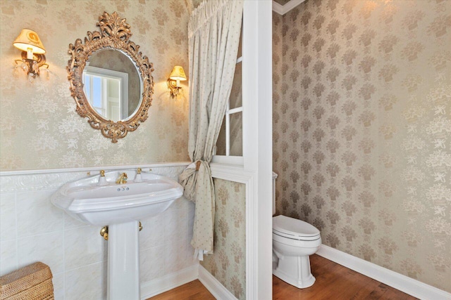 N84W36411 Riverwood Ln, Oconomowoc, WI 53066 - bathroom with hardwood / wood-style floors, toilet, and crown molding