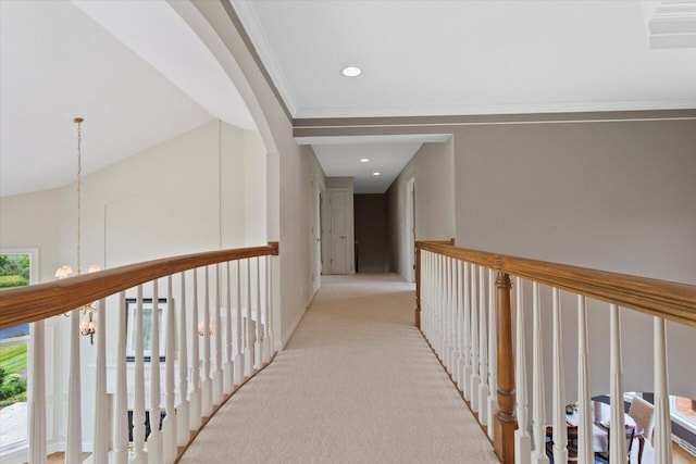 N84W36411 Riverwood Ln, Oconomowoc, WI 53066 - corridor with an inviting chandelier, ornamental molding, lofted ceiling, and light colored carpet