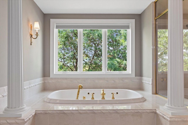 N84W36411 Riverwood Ln, Oconomowoc, WI 53066 - bathroom with decorative columns, a relaxing tiled tub, and a healthy amount of sunlight