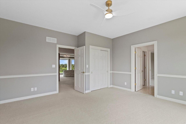 N84W36411 Riverwood Ln, Oconomowoc, WI 53066 - unfurnished bedroom with ceiling fan, light carpet, and a closet