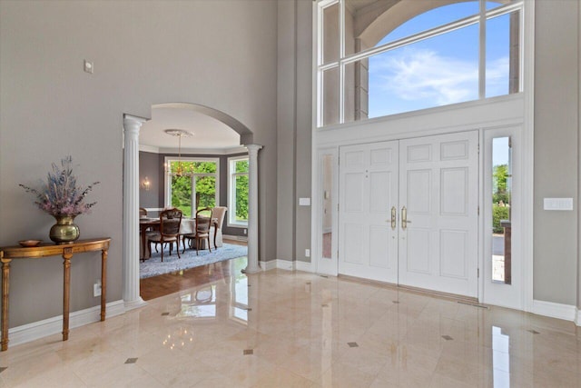 N84W36411 Riverwood Ln, Oconomowoc, WI 53066 - entrance foyer with decorative columns and a towering ceiling