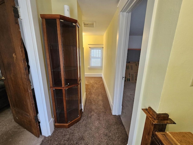 corridor featuring carpet floors and baseboards