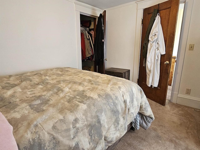 bedroom with carpet floors and crown molding