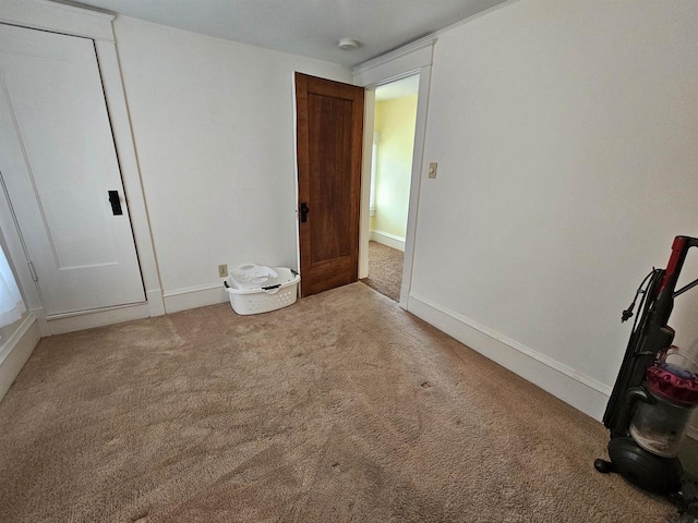 unfurnished bedroom with carpet and baseboards