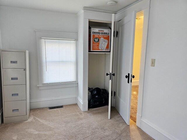 carpeted bedroom with a closet, visible vents, and baseboards