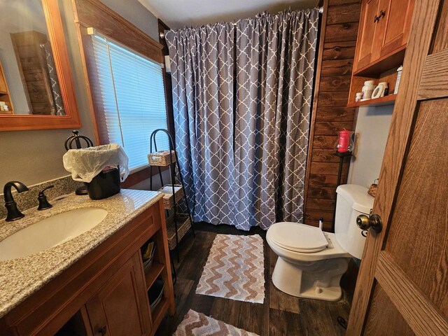 full bath with vanity, wood finished floors, toilet, and a shower with curtain