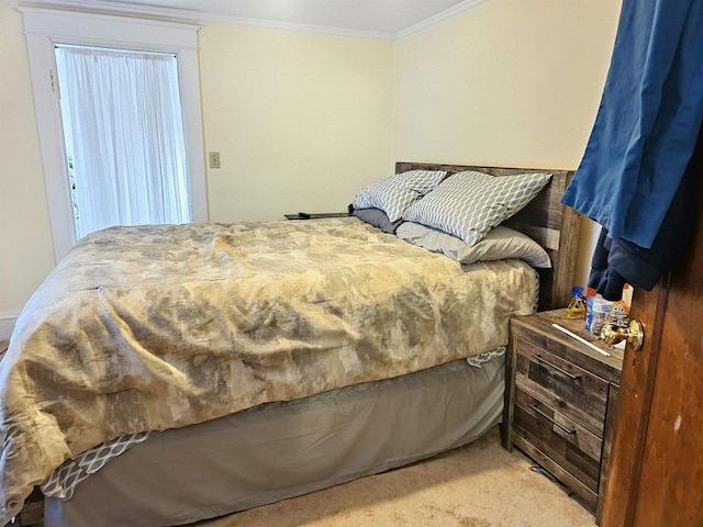 bedroom with ornamental molding and carpet